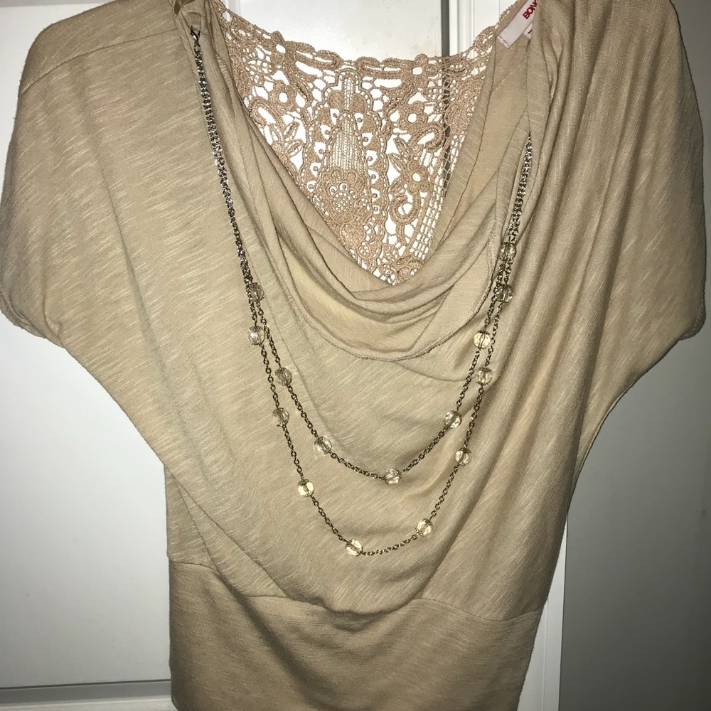 Beige blouse with attachable necklace.